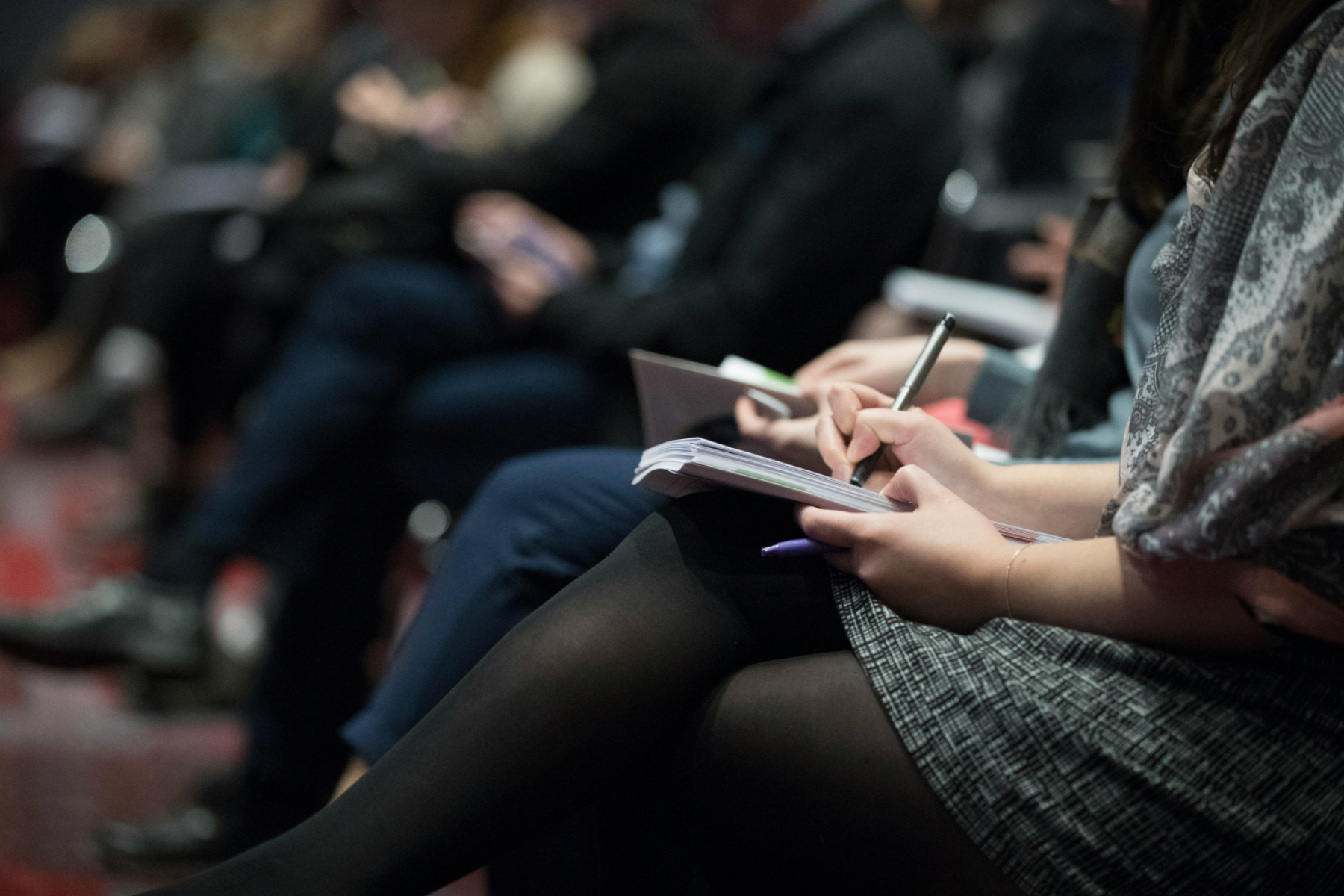 Audience taking notes at a training seminar